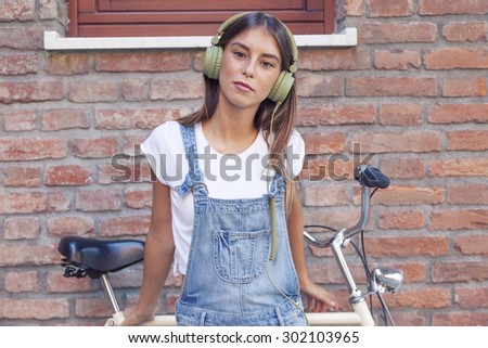 young beautiful woman enjoys music with headphones