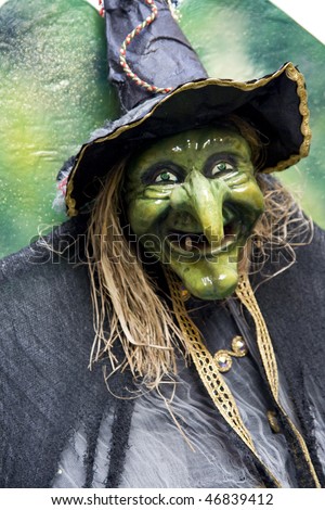 old witch with green face at carnival