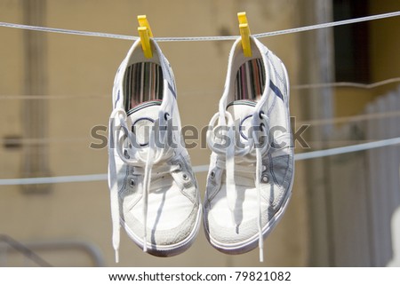 shoes hanging by a thread