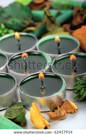 Background of burning tea light candles with decorative petals