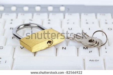 Padlock and keys on computer keyboard; internet security concept.