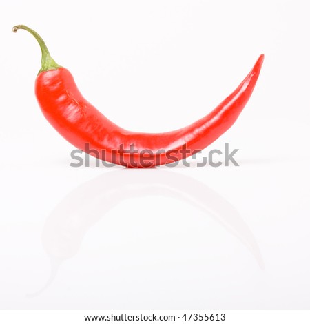 Abstract curved chilli with reflection isolated against white background.