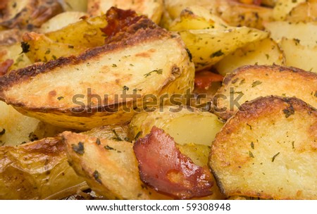 Spicy Potato Wedges with Chorizo Sausage on baking tray straight from oven.