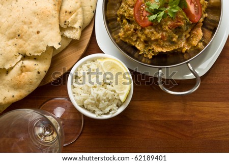 Indian Curry meal of spicy chicken, rice and naan bread.