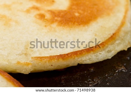 close up of drop scones or pancakes being fried in hot butter.