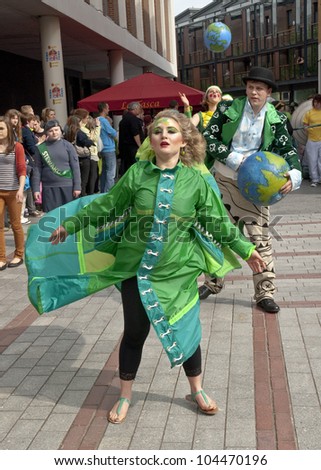 EXETER - MAY 18: The Lady of the Wind, Emma-Rose, dances through the streets of Exeter as part of the Battle for the Winds Parade on May 18, 2012 in Exeter, UK