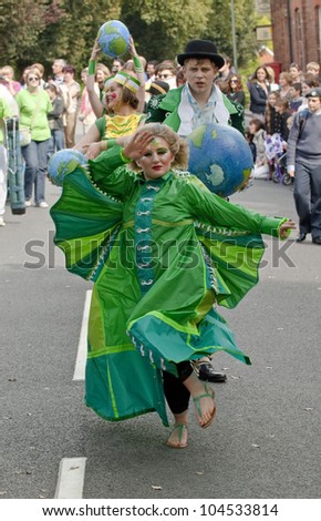 EXETER - MAY 20: The Lady of the Wind, Emma-Rose, dances through the streets of Exeter as part of the Battle for the Winds Parade on May 20, 2012 in Exeter, UK