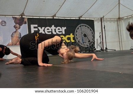 EXETER - JUNE 3: Dancer from State of Emergency Dance Company perform live on the Global Community Stage at the Exeter Respect Festival 2012 on June 3, 2012 in Exeter, UK