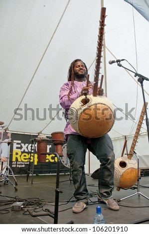 EXETER - JUNE 3: Modou N\'Diaye plays the Kora live on the Global Community Stage at the Exeter Respect Festival 2012 on June 3, 2012 in Exeter, UK