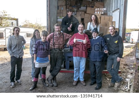 EXETER MARCH 14 Members & volunteers from BookCycle UK pose at the Bookcycle UK warehouse after loading the container bound for Ghana on March 14 2013 in Exeter Devon UK EXETER MARCH 14 Members & volunteers from BookCycle UK pose at the Bookcycle UK warehouse after loading the container bound for Ghana on March 14 2013 in Exeter Devon UK