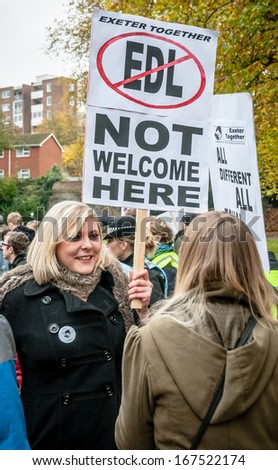 EXETER - NOVEMBER 16: A women holds up a \'EDL Not Welcome Here\' during the Exeter Together march and diversity festival on November 16, 2013 in Exeter, Devon, UK