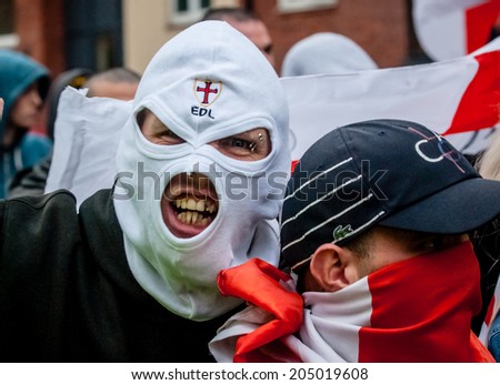 EXETER, UK - NOVEMBER 16: English Defence League member in a white balaclava during the English Defence League march and rally November 16, 2013 in Exeter, Devon, UK