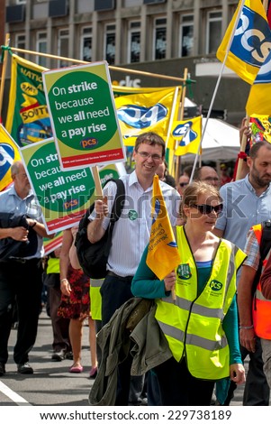 EXETER - JULY 10: PCS members with placards walk along Exeter High Street during the public sector workers national day of action in Exeter City Centre on July 10,  2014 in Exeter, Devon, UK