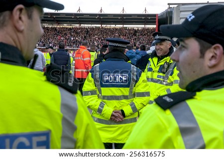 EXETER, ENGLAND - FEBRUARY 21, 2015: Devon and Cornwall Police wait for football fans during the police operation at the League 2 football match between Exeter City FC and Plymouth Argyle FC