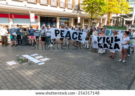 EXETER, ENGLAND - JULY 15, 2014: The peace campaigners hold up peace banners during the Peace Vigil for Gaza in Exeter\'s Princesshay Square.