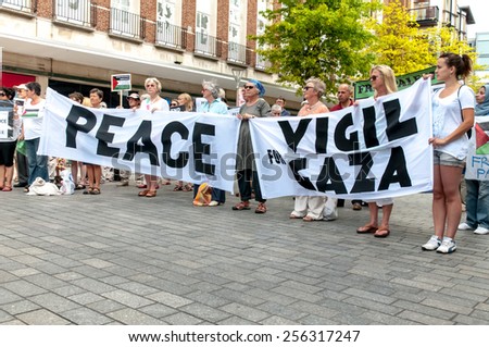 EXETER, ENGLAND - JULY 15, 2014: The peace campaigners hold up peace banners during the Peace Vigil for Gaza in Exeter\'s Princesshay Square.