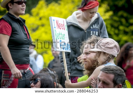 EXETER, ENGLAND - JUNE 13, 2015: Child holding a placard, which says, \
