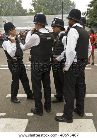 LONDON - AUGUST 25: British police gathering at the Notting Hill Carnival on August 25, 2008 in London, England.