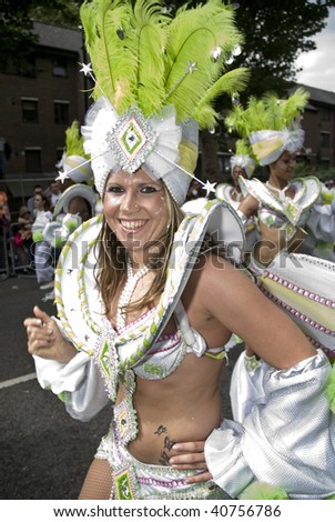 LONDON - AUGUST 31: A dancer from the London School of Samba float during the Notting Hill Carnival on August 31, 2009 in London, England.