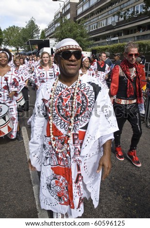 NOTTING HILL, LONDON - AUG 31:  The band leader from Batala Banda de Percussao leading the band throught the streets at the Notting Hill Carnival August 30, 2010 in Notting Hill, London, England