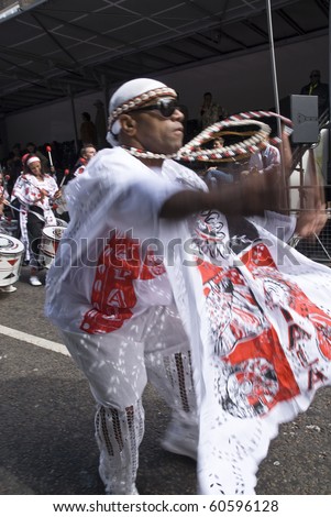 NOTTING HILL, LONDON - AUG 31: The band leader from Batala Banda de Percussao leading the band through the streets at the Notting Hill Carnival August 30, 2010 in Notting Hill, London, England