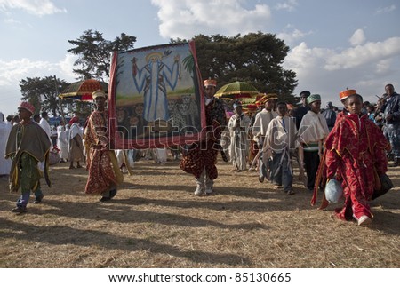 JAR MADA, ADDIS ABABA -  JAN 18:  Christian Orthodox devotees carry religious pictures at the Timket Festival. January 18, 2009 in Jar Mada, Addis Ababa, Ethiopia