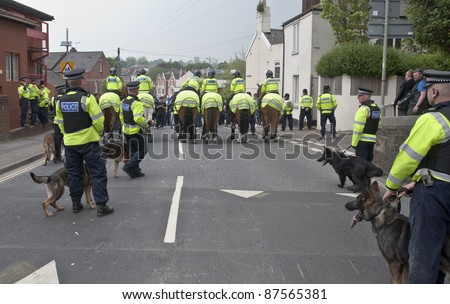 EXETER - APRIL 30:Devon and Cornwall Police prevent violence at the football match between Exeter City FC and Plymouth Argyle FC at Exeter\'s St James Park Football ground on April 30, 2011 in Exeter