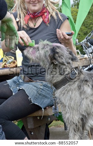 EXETER, UK - JUNE 11:A woman teats her dog at the Exeter Naked Bike Ride. A peaceful and fun protest that highlighted non-oil dependent modes of transport on June 11, 2011 in Exeter