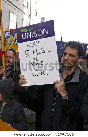 EXETER - NOVEMBER 30: Man holds up a UNISON placard saying \