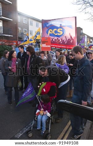 EXETER - NOVEMBER 30: Parents with children and many other join the march through Exeter City centre , t against proposed changes to public sector pensions  on November 30, 2011 in Exeter, UK