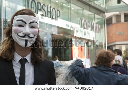 EXETER - JANUARY 28: An Occupy Exeter activist wearing a Guy Fawkes mask outside the Exeter branch of Topshop  on January 28, 2012 in Exeter, UK