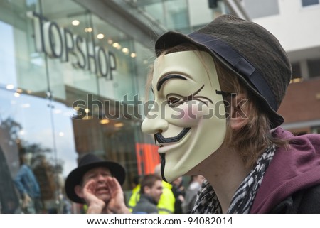 EXETER - JANUARY 28: An Occupy Exeter activist wearing a Guy Fawkes mask outside the Exeter branche of Topshop  on January 28, 2012 in Exeter, UK