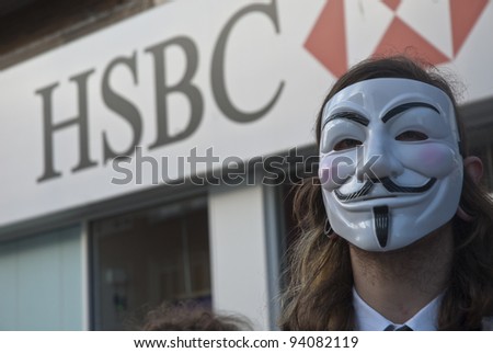 EXETER - JANUARY 28: Occupy Exeter activist wearing a Guy Fawkes mask campaigning outside the Exeter branch of HSBC bank  on January 28, 2012 in Exeter, UK