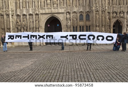 EXETER - FEBRUARY 11: The huge Occupy Exeter banner made for site 2  of Exeter Cathedral during Occupy Exeter's leaving celebrations on Exeter Cathedral Green  on February 11, 2012 in Exeter, UK