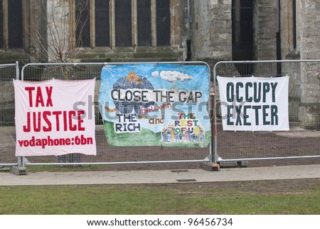 EXETER - FEBRUARY 11: A Tax Justice banner another banner saying 