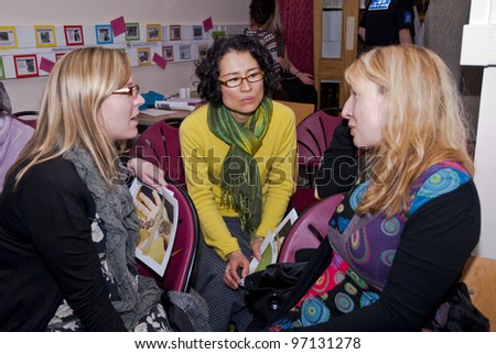 EXETER - MARCH 8 : Members of the audience in discussion at the International Women\'s Day event at the St Sidwell\'s Centre in Exeter,  Devon  on March 8, 2012 in Exeter Devon uk