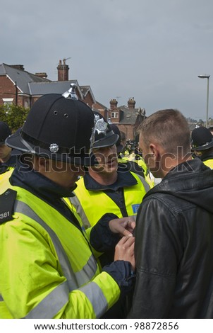 EXETER - APRIL 30:Plymouth Argyle supporter being searched by police at the League 1 match between Exeter City FC and Plymouth Argyle FC on April 30, 2011 in Exeter, UK.