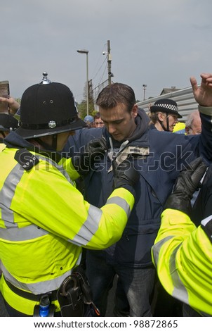 EXETER - APRIL 30: Plymouth Argyle supporter being searched by police at the League 1 match between Exeter City FC and Plymouth Argyle FC on April 30, 2011 in Exeter, UK.