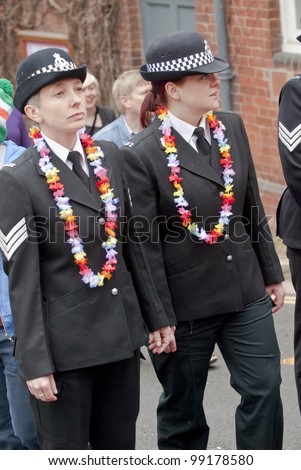 EXETER - MARCH 31: Festival goers dressed as police officers march through the streets of Exeter City at the Exeter Pride 2012 Parade in Exeter City centre on March 31, 2012 in Exeter, UK.