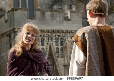 EXETER - APRIL 6: Actress plays out a convesation with Jesus during the Good Friday Walk of Witness on Exeter Cathedral Green on April 6, 2012 in Exeter, UK