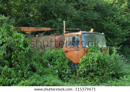 Disused Council Drain Cleaner Lorry overgrown with Himalayan Balsam, Bindweed and Nettles