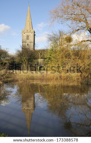 Ashleworth Church reflected in flood water on the banks of the River Severn