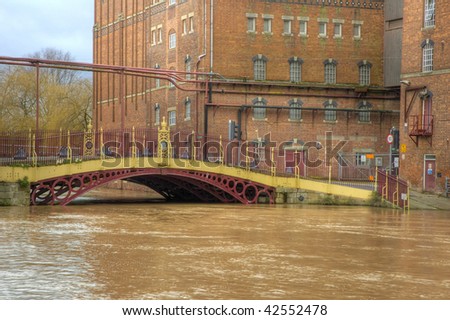 High water at Quay Street Bridge Decorated Iron bridge and Healings Flour Mill during Flood