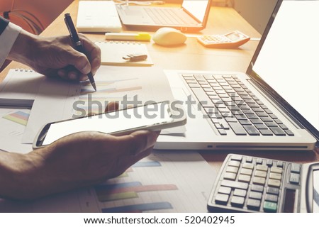 Businessman working with laptop in office.