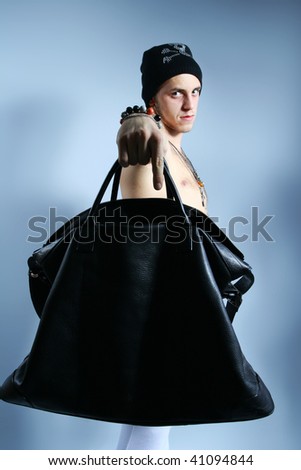 young cool guy showing big black bag to the camera