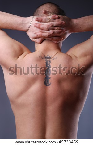 stock photo portrait of handsome strong man's back with tatoo