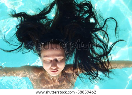 Beautiful young woman in a swimming pool