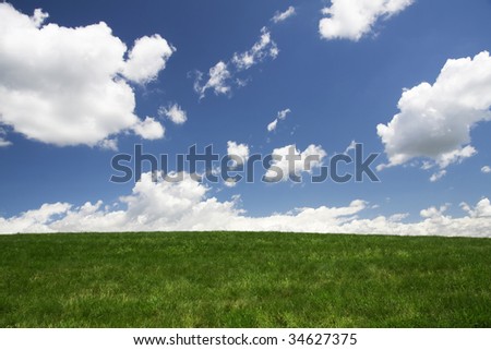 Clouds rolling over green pasture