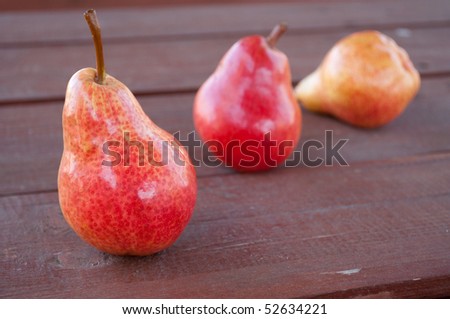 three pears on the wooden background
