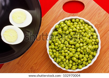 Directly above photograph of eggs and a plate of peas.